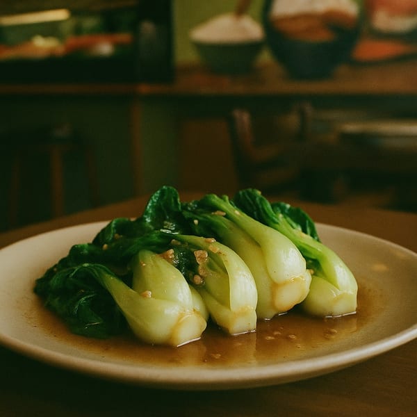 Steamed bok choy with garlic sauce on a white plate at Sage Sushi Lounge.
